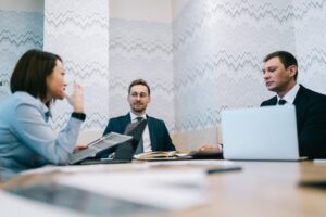 experts in a meeting room, discussing erp for service management