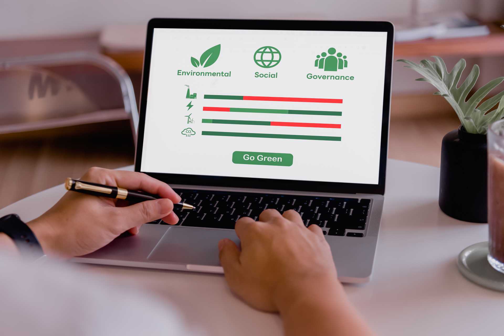 business central sustainability, Using ESG software on a laptop screen.
