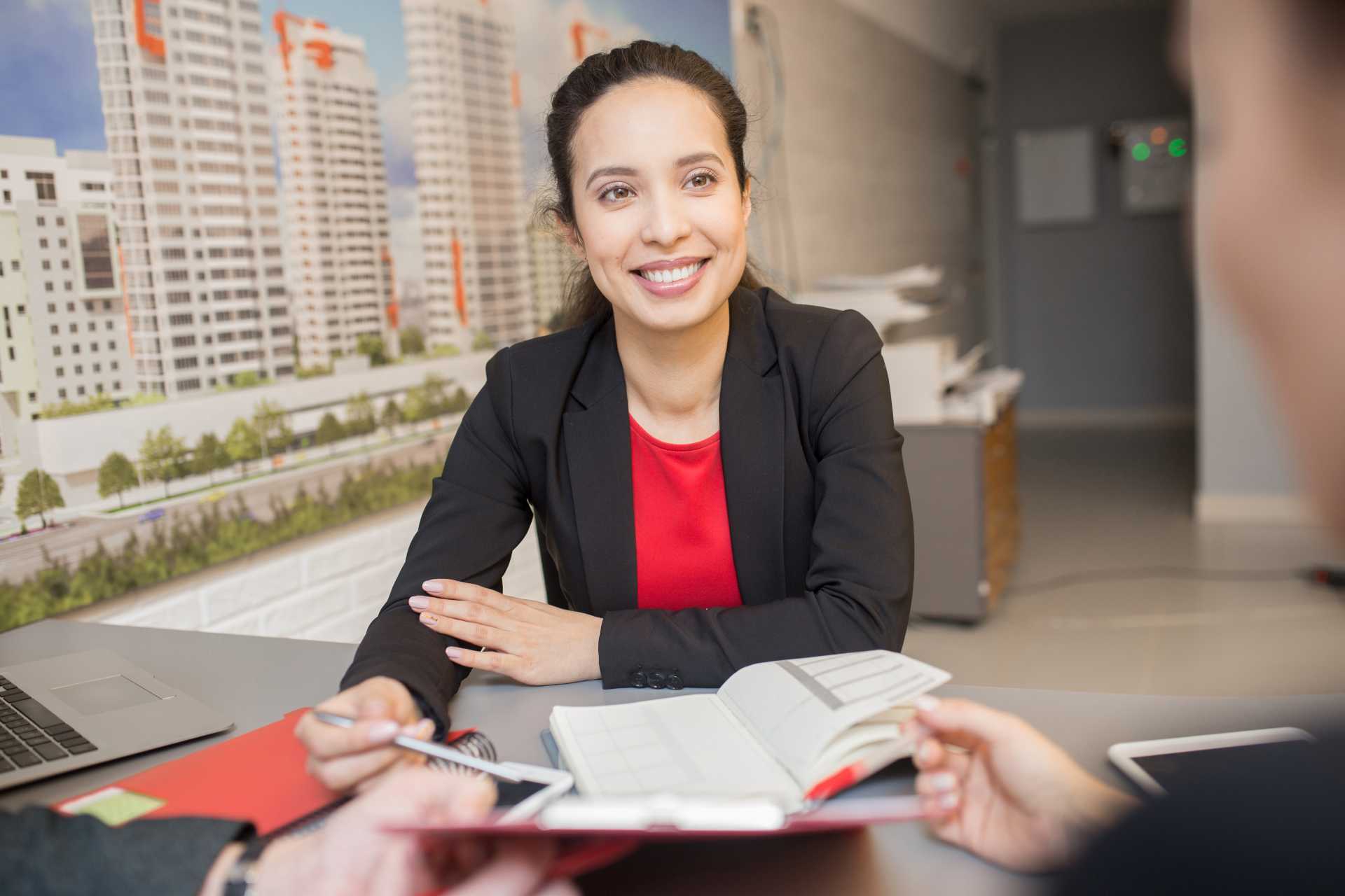 operational challenges in property management, a smiling property manager in a meeting.