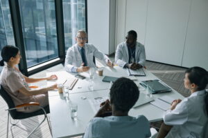 professionals sitting around a table discussing erp replacement