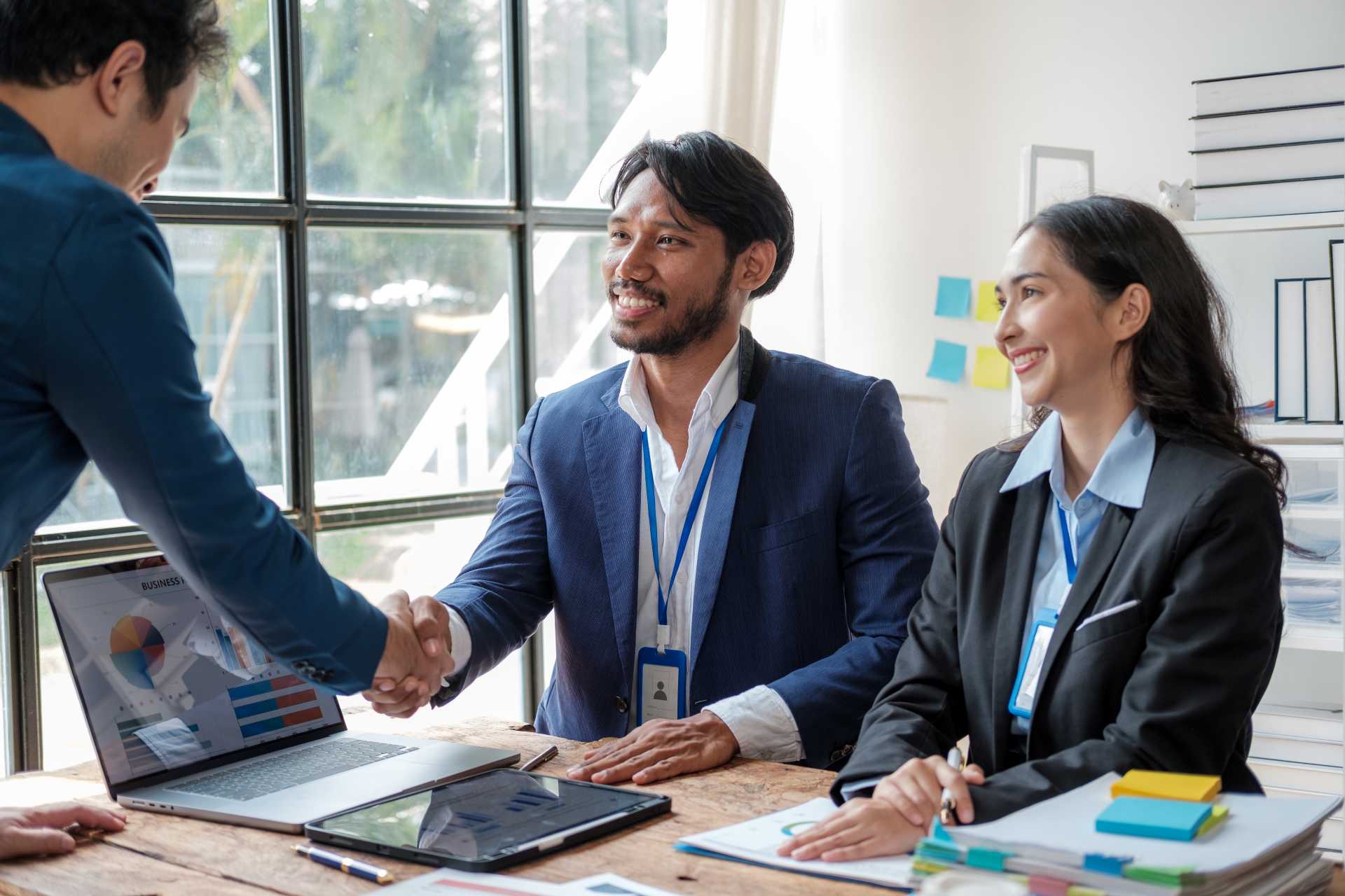 ERP partner as strategic advisor, Young professionals shaking hands after a meeting.