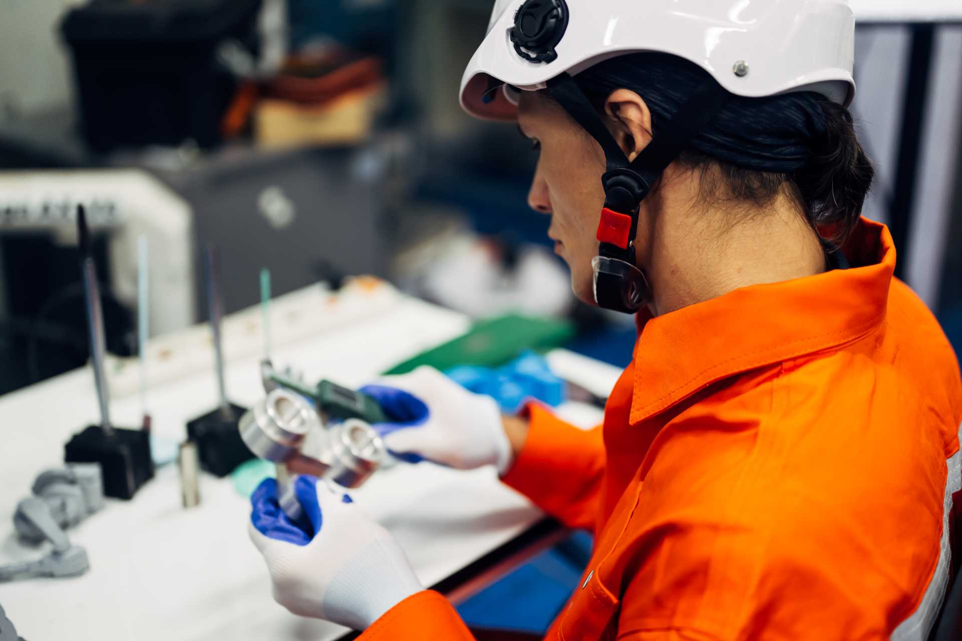 business central quality control, An engineer inspecting a machining component.